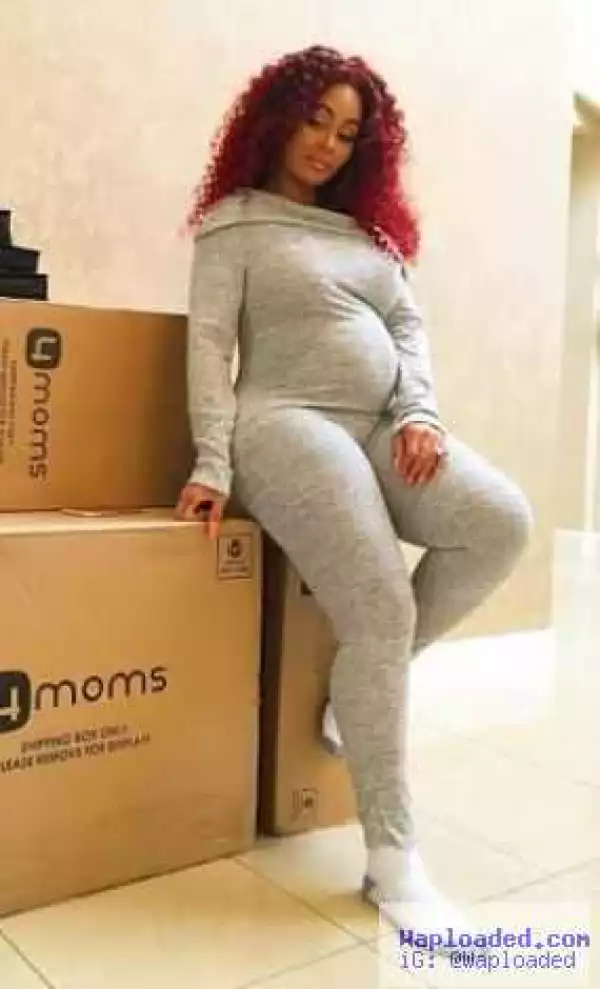 Blac Chyna shows of her growing baby bump in gray jumpsuit